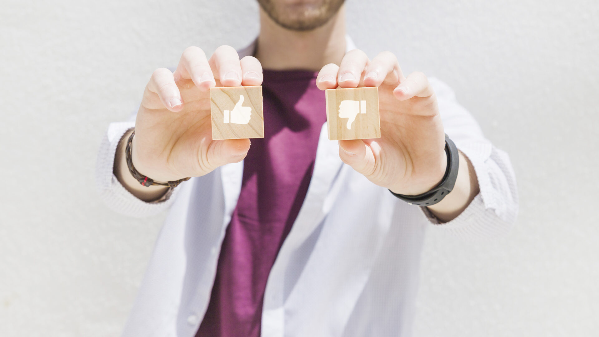 Doctor holding a like and dislike wooden block